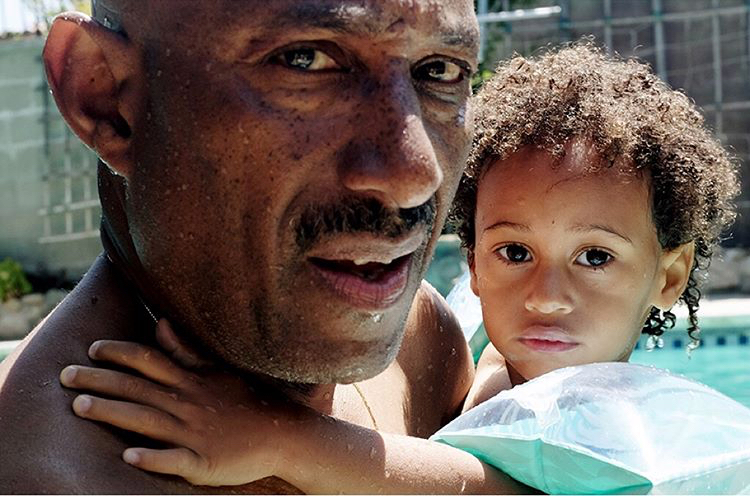 A father holding his young child