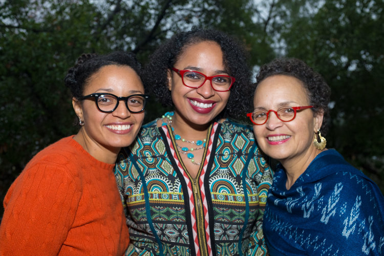 Three generations of women smiling together outdoors